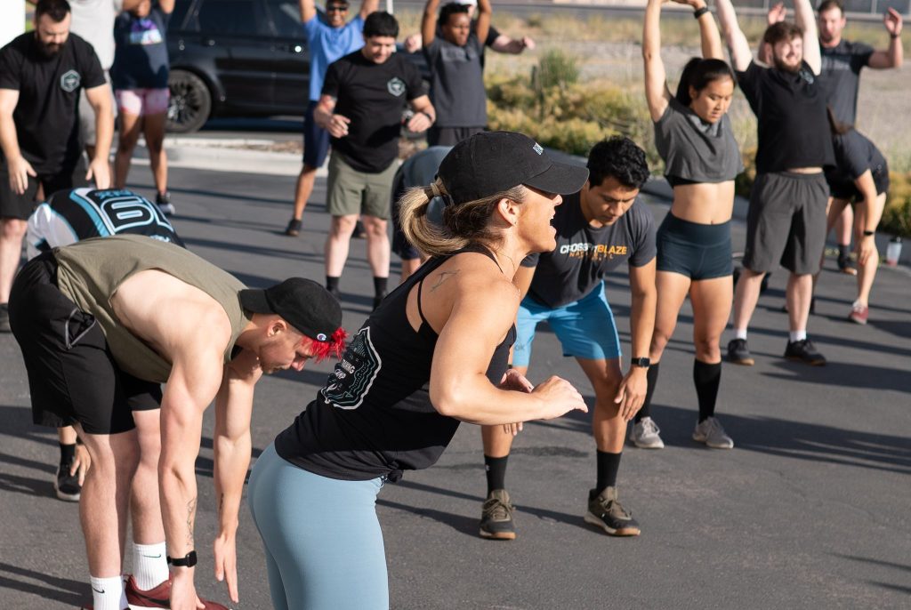 Fitness coach leading a class during HIIT workout warmup